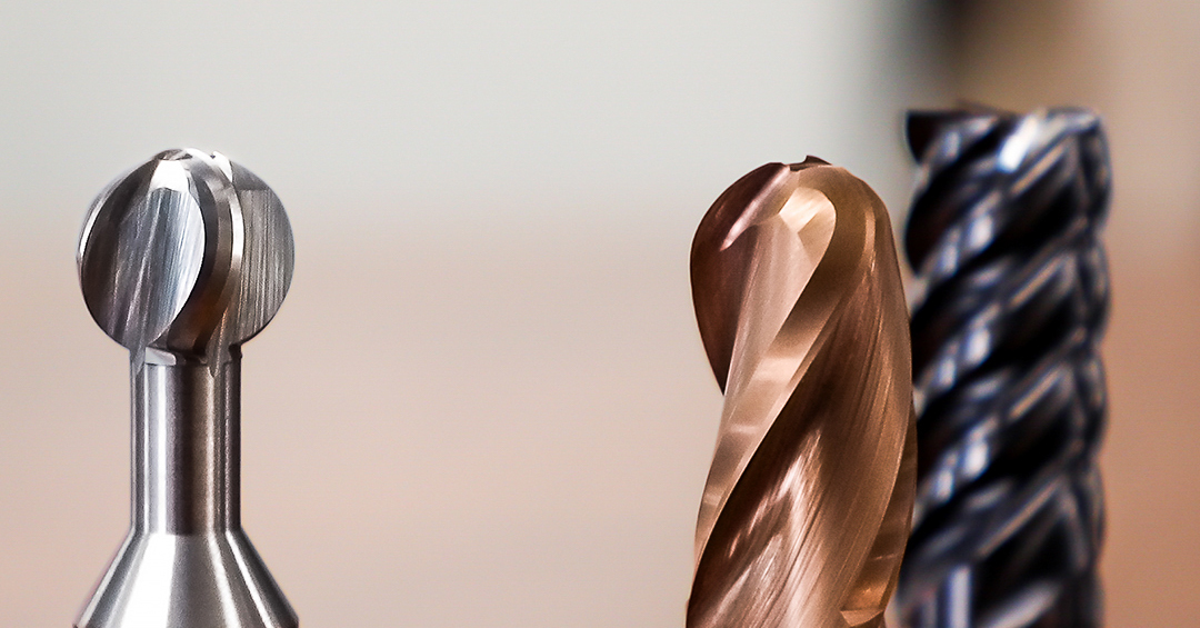 up-close shot of three different sonic tools. One is a multi-flute end mill, one is a ball-end mill, and the last is a spherical cutter.
